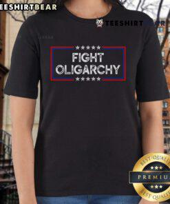 Activist ladies wearing 'Top Fight Oligarchy, Stand Against Corporate Greed' tees, promoting social justice and awareness.