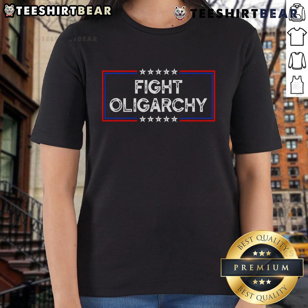 Activist ladies wearing 'Top Fight Oligarchy, Stand Against Corporate Greed' tees, promoting social justice and awareness.