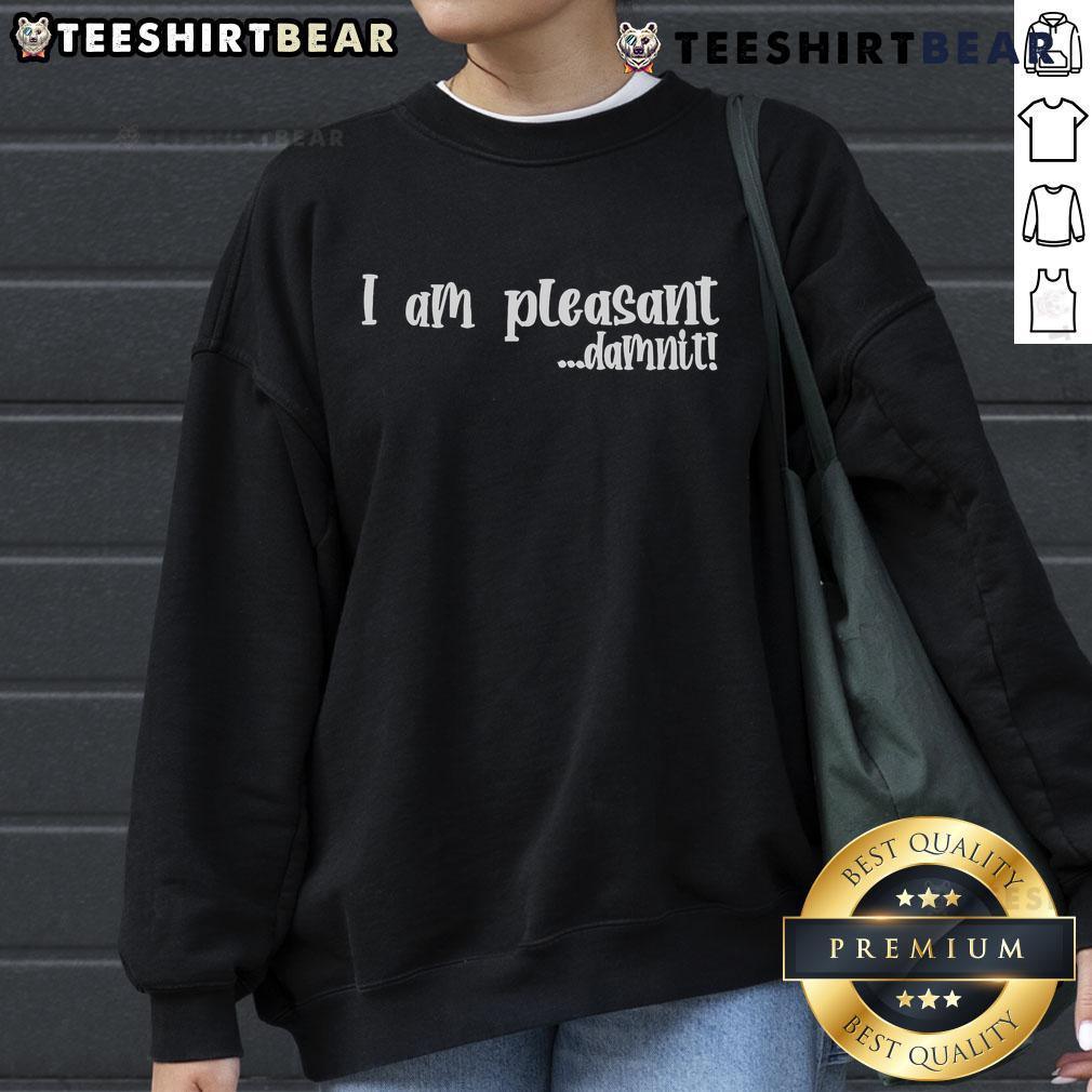 Top I Am Pleasant Damnit Sweatshirt displayed on a wooden table with casual styling, perfect for cozy outfits.