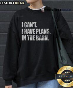 Cozy Top I Can't I Have Plans In The Barn Sweatshirt in a rustic setting, perfect for casual farm outings and cozy gatherings.
