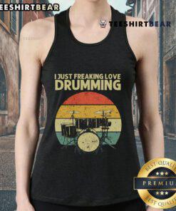 Retro sunset tank top featuring the phrase 'I Just Freaking Love Drumming' worn by a drummer against a colorful backdrop.