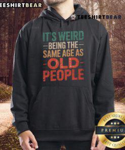 Cozy hoodie featuring the phrase 'It's Weird Being the Same Age as Old People' for a humorous fashion statement.