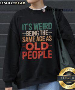 Stylish sweatshirt reading 'It's Weird Being The Same Age As Old People,' perfect for casual wear and humor lovers.