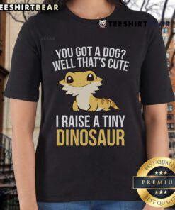 Bearded dragon on a ladies tee, showcasing a fun 'I Raise A Tiny Dinosaur' design featuring lizards and geckos.