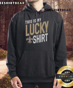 Alt Text: Man wearing 'This Is My Lucky Hoodie' showcasing New Orleans Saints pride at a game.