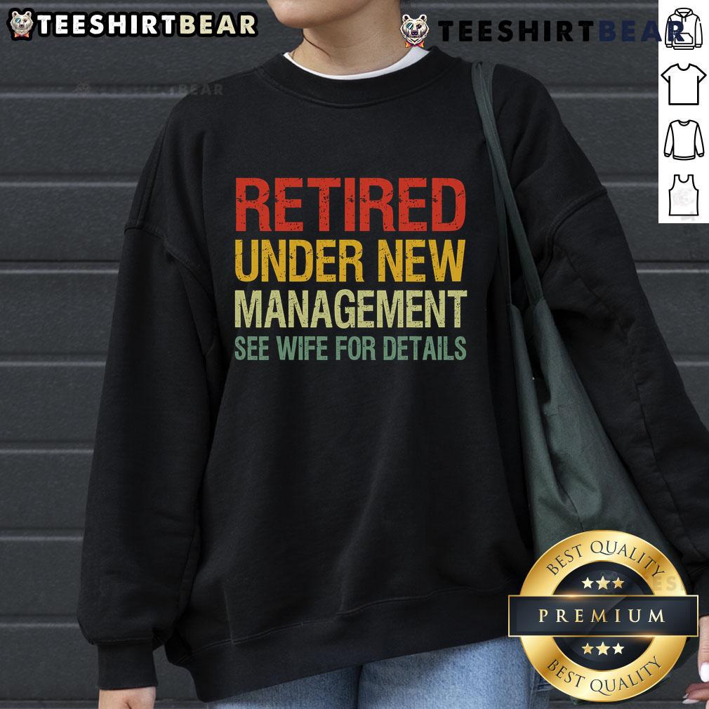 Cozy sweatshirt reading 'Top Retired Under New Management See Wife For Details,' perfect for casual wear and retirement humor.