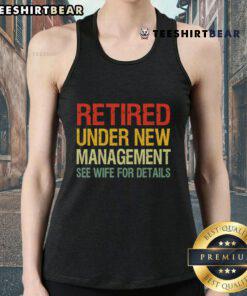 Woman wearing a 'Top Retired Under New Management' tank top, showcasing a fun and humorous retirement message.