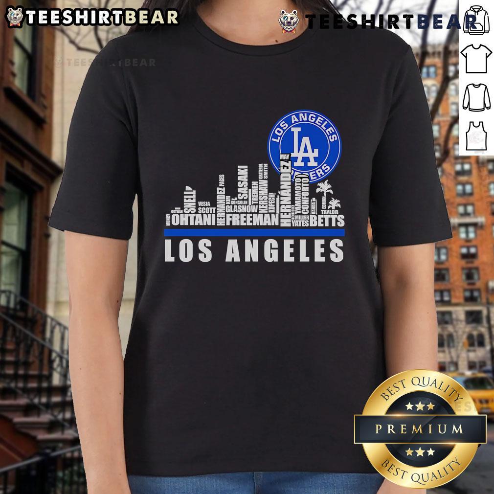Los Angeles Dodgers players' names and logo on a stylish ladies tee with a top skyline city background.