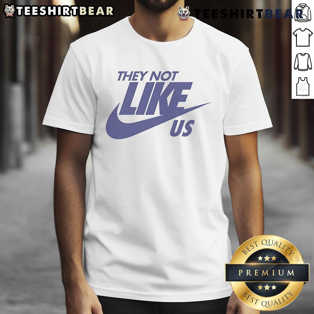 Top They Not Like Us Nike T-Shirt in black, featuring bold white text and a stylish design for casual wear.