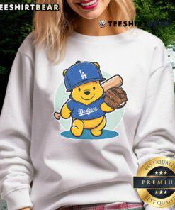 Alt Text: Adorable Winnie the Pooh sweatshirt featuring LA Dodgers logo, perfect for baseball fans and cozy wear.