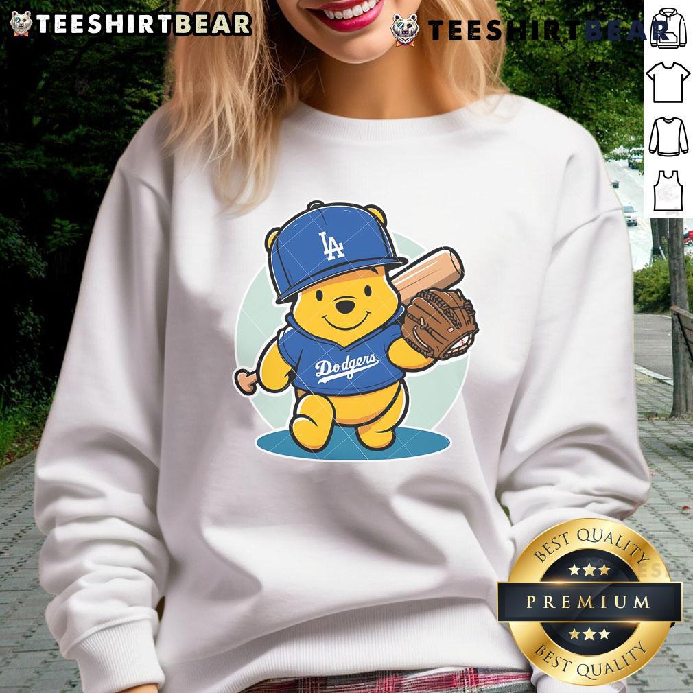Alt Text: Adorable Winnie the Pooh sweatshirt featuring LA Dodgers logo, perfect for baseball fans and cozy wear.