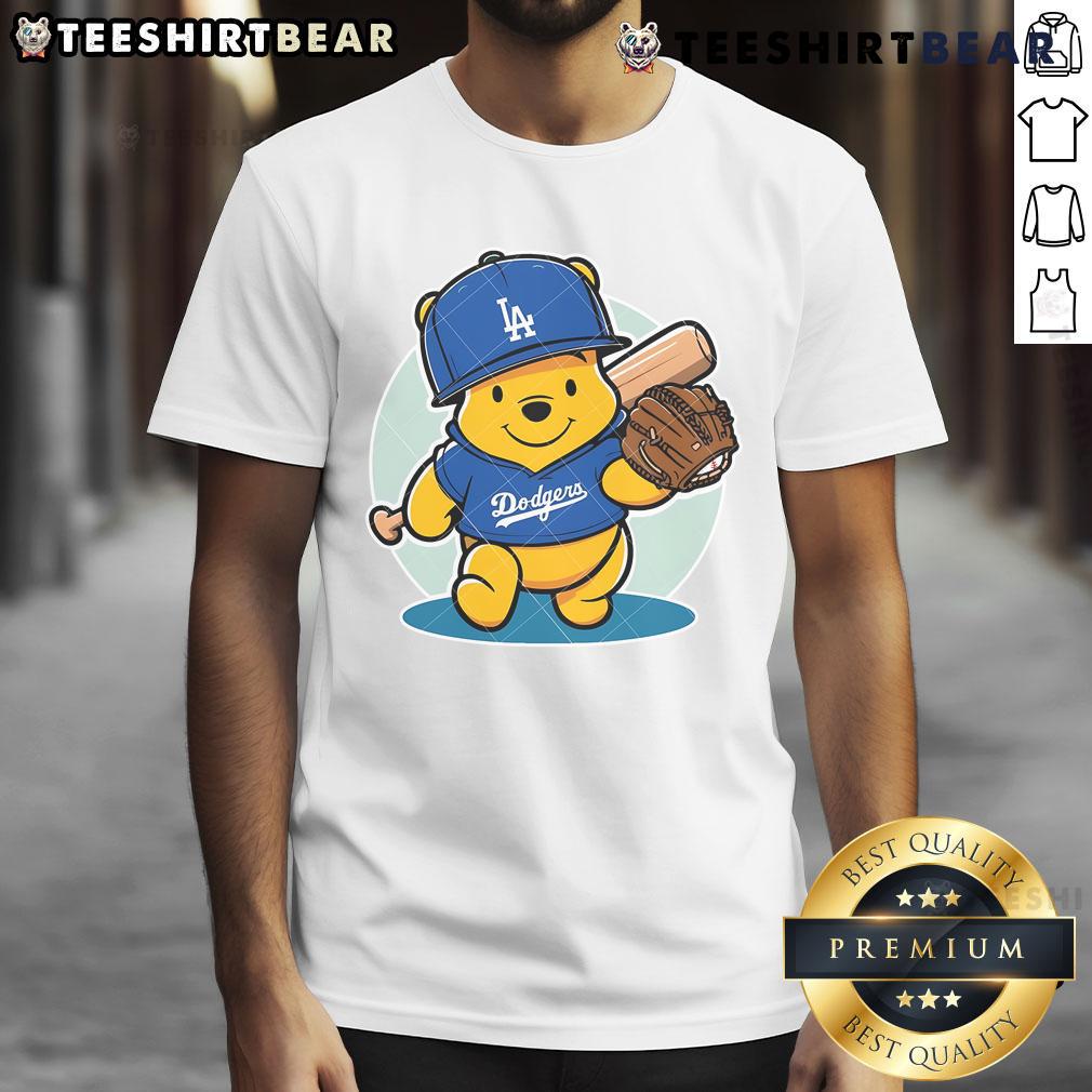 Alt Text: Cute Winnie The Pooh Dodgers baseball t-shirt featuring Pooh in LA Dodgers gear, perfect for fans and collectors.