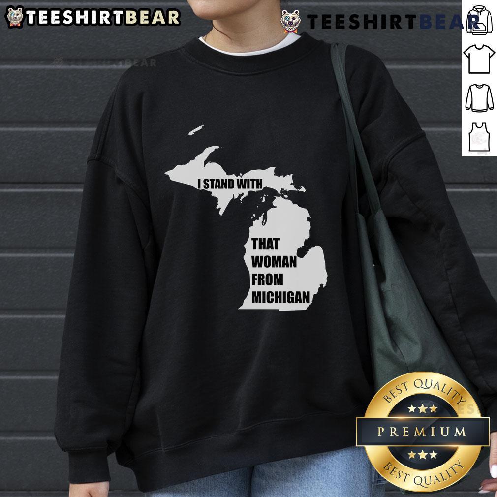 Good I Stand With That Woman From Michigan sweatshirt displayed on a hanger, showcasing its vibrant design and colors.