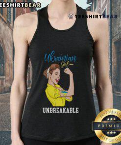 Ukrainian girl in a messy bun wearing a tank top with the Ukraine flag, celebrating her heritage and culture.