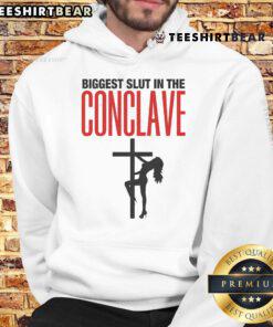 Hot Biggest Slut In The Conclave Hoodie worn by a model, showcasing trendy streetwear style and bold graphic design.