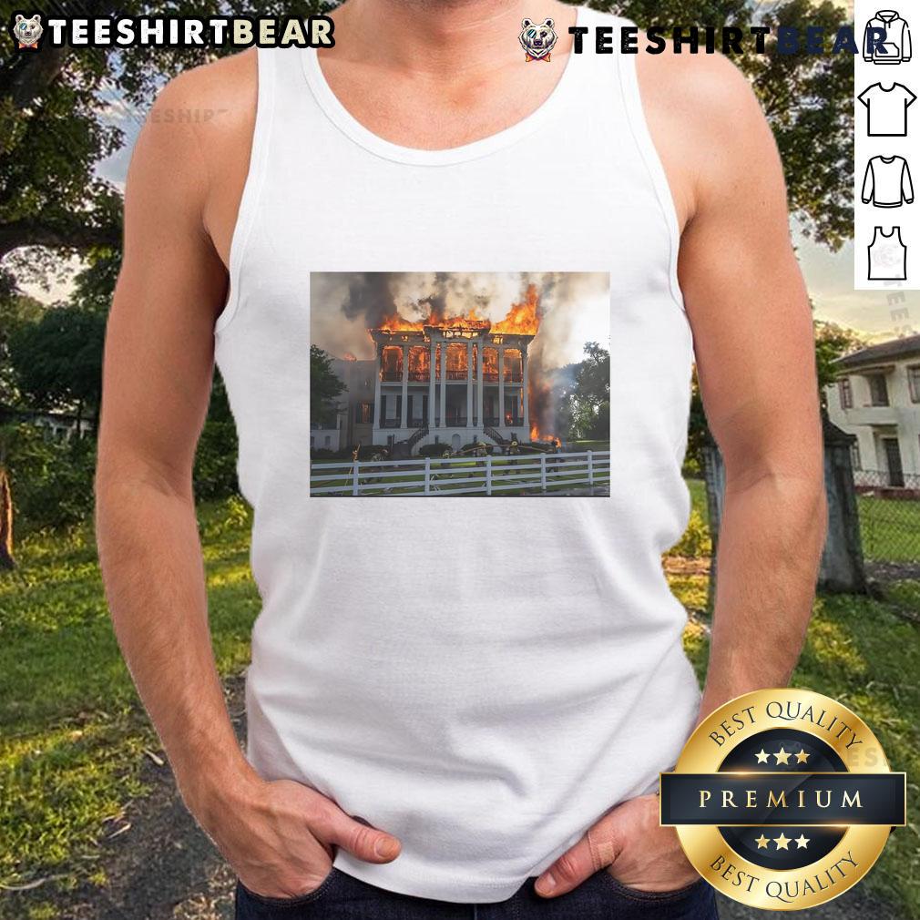 Model wearing a Hot Nottoway Plantation fire tank top, showcasing vibrant design and comfortable fit in a scenic outdoor setting.