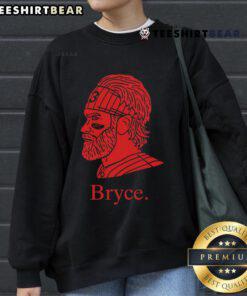 Bryce Harper wearing a stylish Phillies sweatshirt, showcasing team spirit and fan pride in a casual setting.