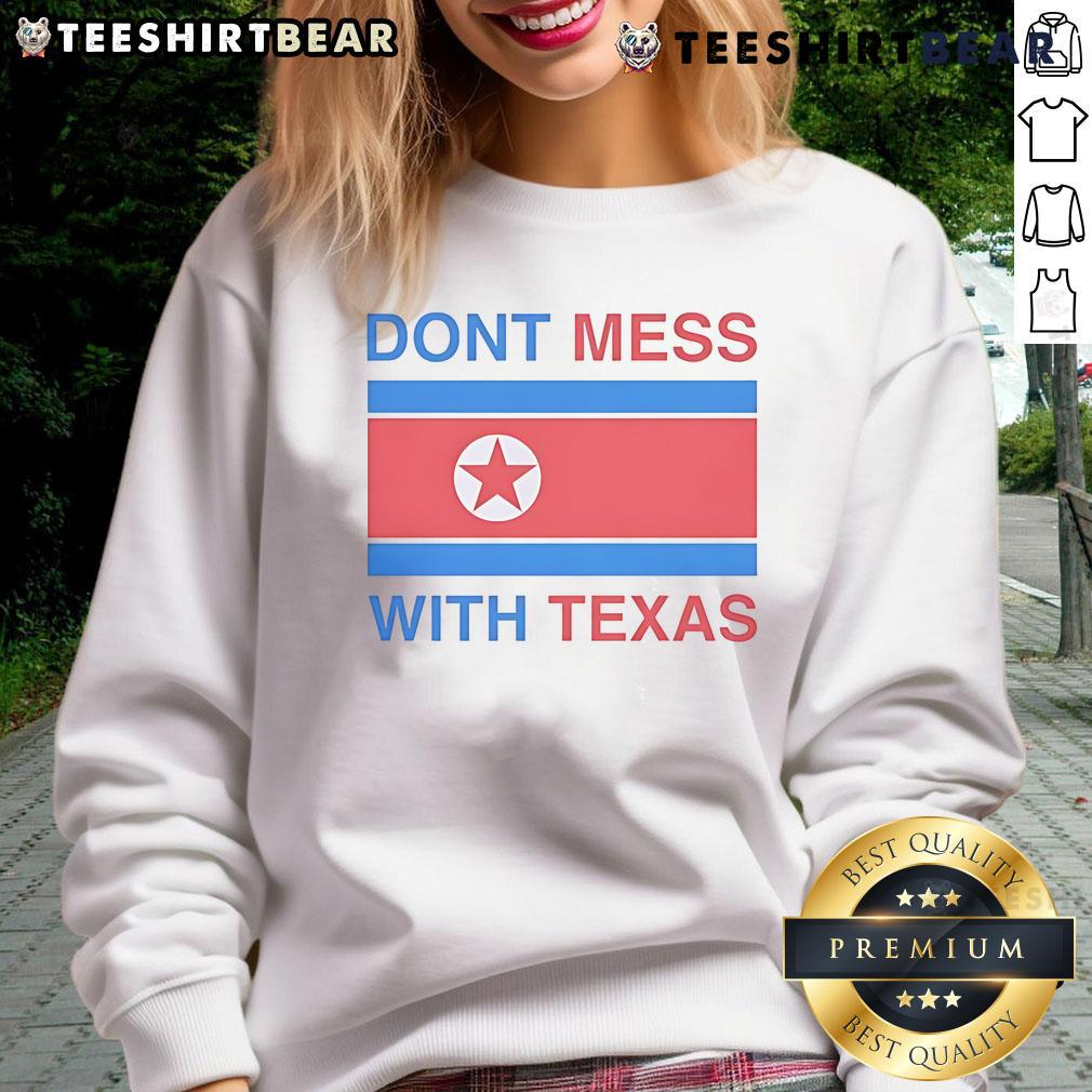 Nice Don't Mess With Texas sweatshirt displayed on a wooden surface, showcasing Texas pride and stylish comfort.