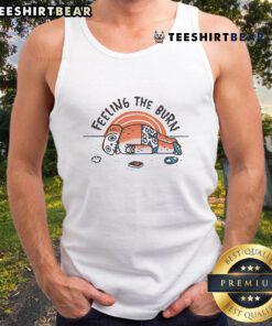 Person wearing a tank top with 'Nice Feeling the Burn' at the beach, showcasing sunburn and summer vibes.