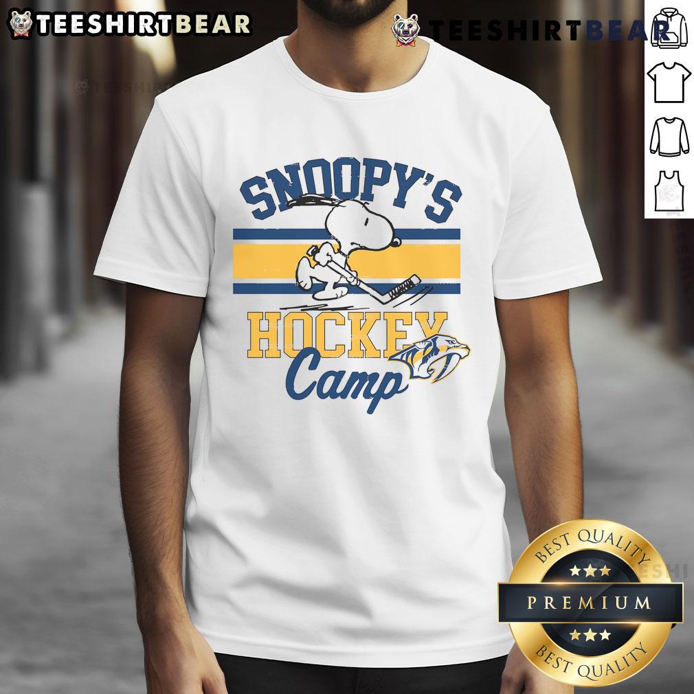 Alt Text: Official Snoopy Nashville Predators T-Shirt from Snoopy's Hockey Camp featuring NHL team logos and vibrant design.