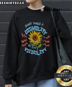 Sunflower sweatshirt with the message 'Don't Judge A Disability By Its Visibility' promoting disability awareness.