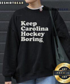 Top Keep Carolina Hockey Boring Sweatshirt featuring bold text and a stylish design, perfect for hockey fans.