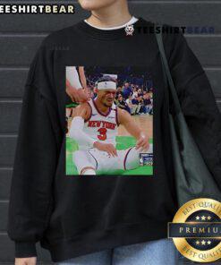 Josh Hart reacts after getting elbowed in the face, wearing a sweatshirt, capturing a dramatic moment in sports.