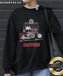 Alt Text: Snoopy and Woodstock driving a motorbike on a vibrant LA Clippers sweatshirt, showcasing fun sports-themed apparel.