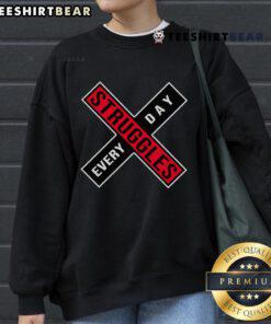 Cozy 'Top Struggles Every Day' sweatshirt displayed on a hanger, perfect for casual wear and expressing daily challenges.
