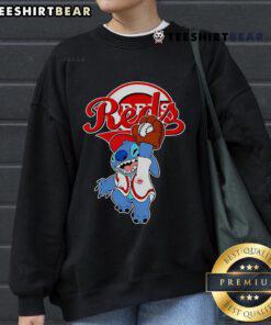 Alt Text: Cute Stitch playing baseball in a Cincinnati Reds sweatshirt, perfect for fans and stylish sportswear enthusiasts.
