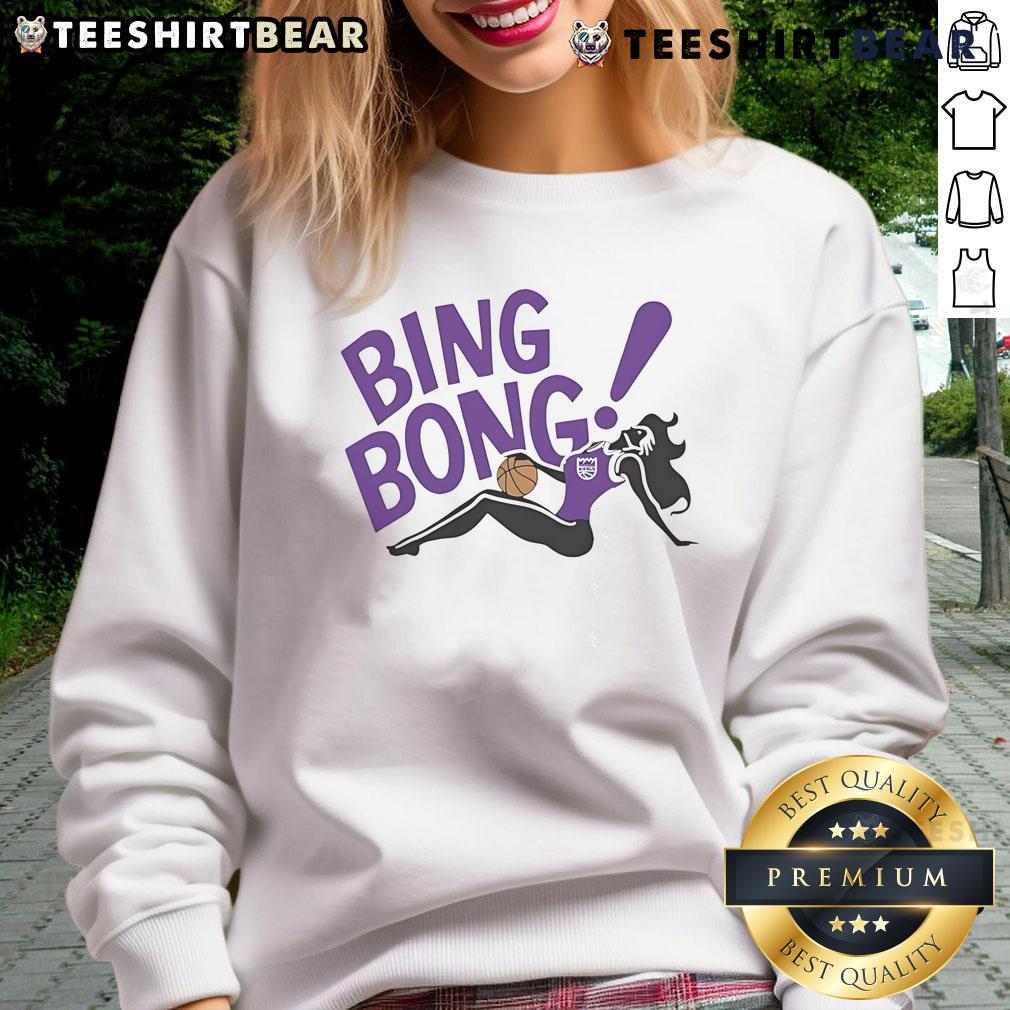 Girl wearing a Sacramento Kings Bing Bong sweatshirt, showcasing team spirit and style in vibrant colors.