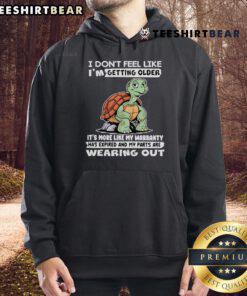 Alt Text: Cozy hoodie featuring a turtle graphic and a humorous quote about aging, perfect for casual wear enthusiasts.