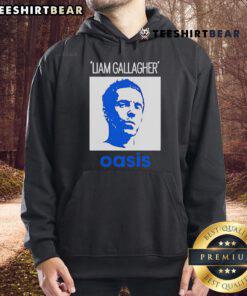 Alt Text: Liam Gallagher wearing an Oasis hoodie, showcasing his iconic style in a striking portrait. Official merchandise.