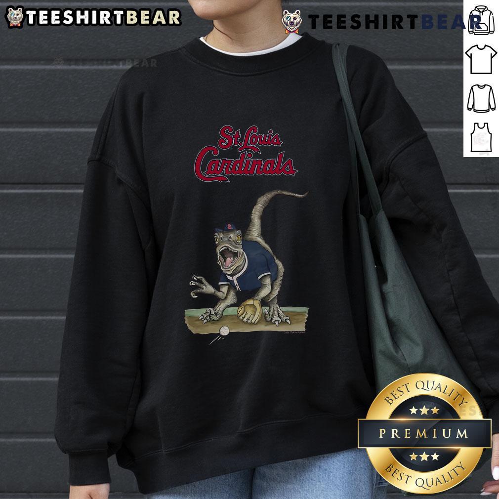 Official St. Louis Cardinals Tiny Turnip Velociraptor Sweatshirt in red, featuring a playful dinosaur design for fans.