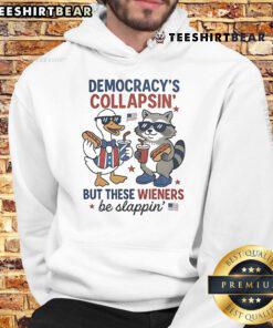 Funny Fourth of July hoodie featuring a duck and raccoon with the phrase 'Democracy's collapsing, but these wieners be slapping.'
