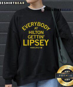 Group of friends wearing Lipsey sweatshirts at Hilton event, showcasing trendy fashion and vibrant atmosphere.