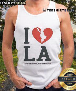 Model wearing 'I Heart Broken LA' tank top, promoting the message 'Fight Ignorance, Not Immigrants' in a stylish design.