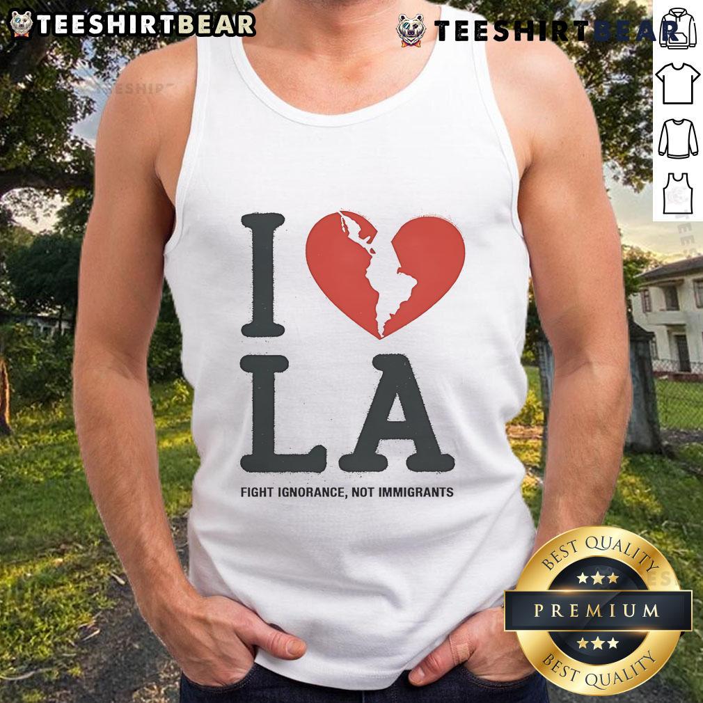 Model wearing 'I Heart Broken LA' tank top, promoting the message 'Fight Ignorance, Not Immigrants' in a stylish design.