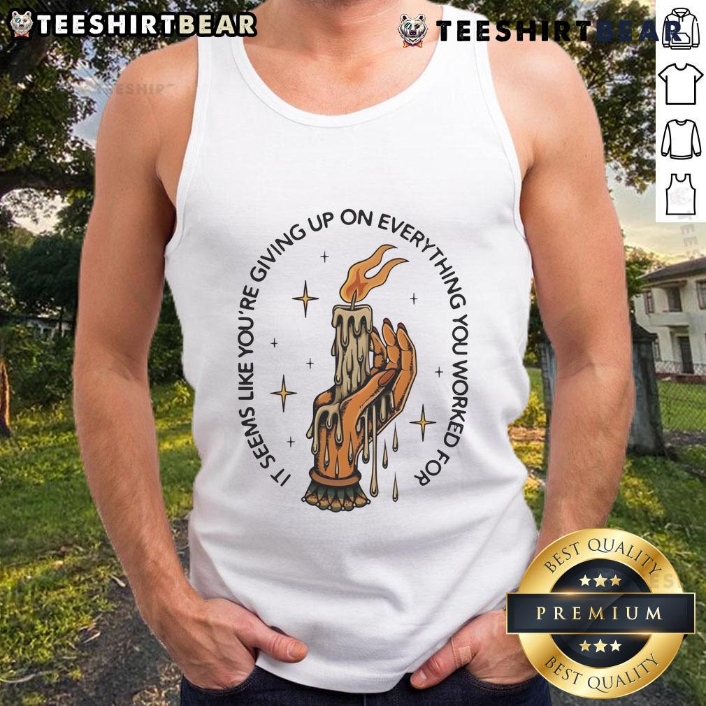 Alt Text: Candle in hand, woman in a tank top looks contemplative, embodying the phrase 'Seems like youre giving up'.