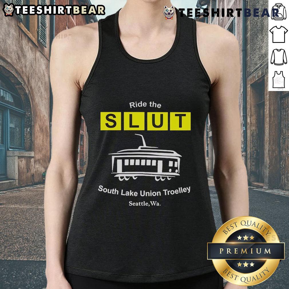 Man wearing a 'Top Ride The SLUT South Lake Union Trolley Seattle WA' tank top, standing by the trolley in Seattle.