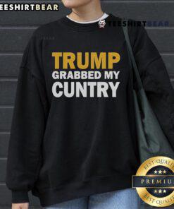 Cozy 'Top Trump Grabbed My Cuntry' sweatshirt in a casual setting, perfect for expressing political humor and style.