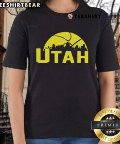 Stylish 2025 Ladies Tee featuring the vibrant skyline of Utah Jazz cityscape, perfect for fans and fashion lovers.