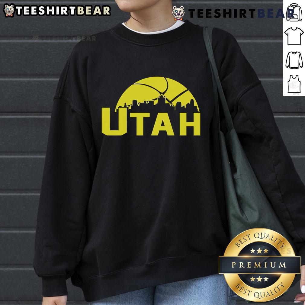 Stylish 2025 Utah Jazz cityscape skyline sweatshirt featuring vibrant colors and team logo, perfect for fans.