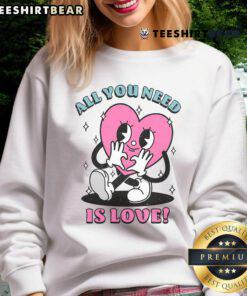 Alt Text: Cute All You Need Is Love sweatshirt featuring a heart design, perfect for cozy casual outfits.