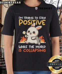 Adorable bunny graphic on a ladies' tee, promoting positivity amid chaos with the phrase Trying to Stay Positive.