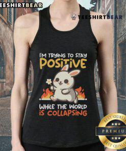 Cute bunny wearing a tank top that says I'm Trying to Stay Positive While the World is Collapsing, spreading positivity.
