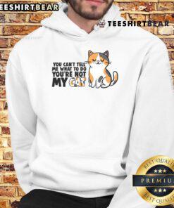 Adorable cat wearing a hoodie with 'You Can't Tell Me What To Do, You're Not My Cat' print, showcasing playful attitude.