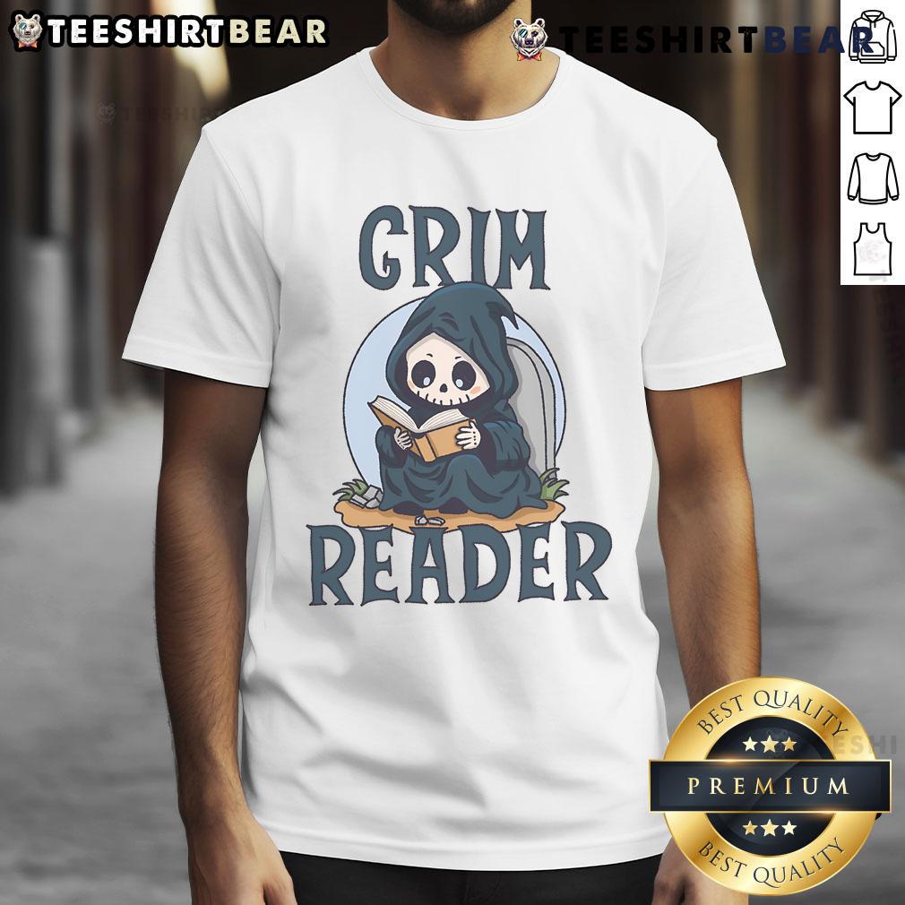 Alt Text: Cute Grim Reader wearing a whimsical T-shirt, engrossed in a book, perfect for book lovers and Halloween enthusiasts.