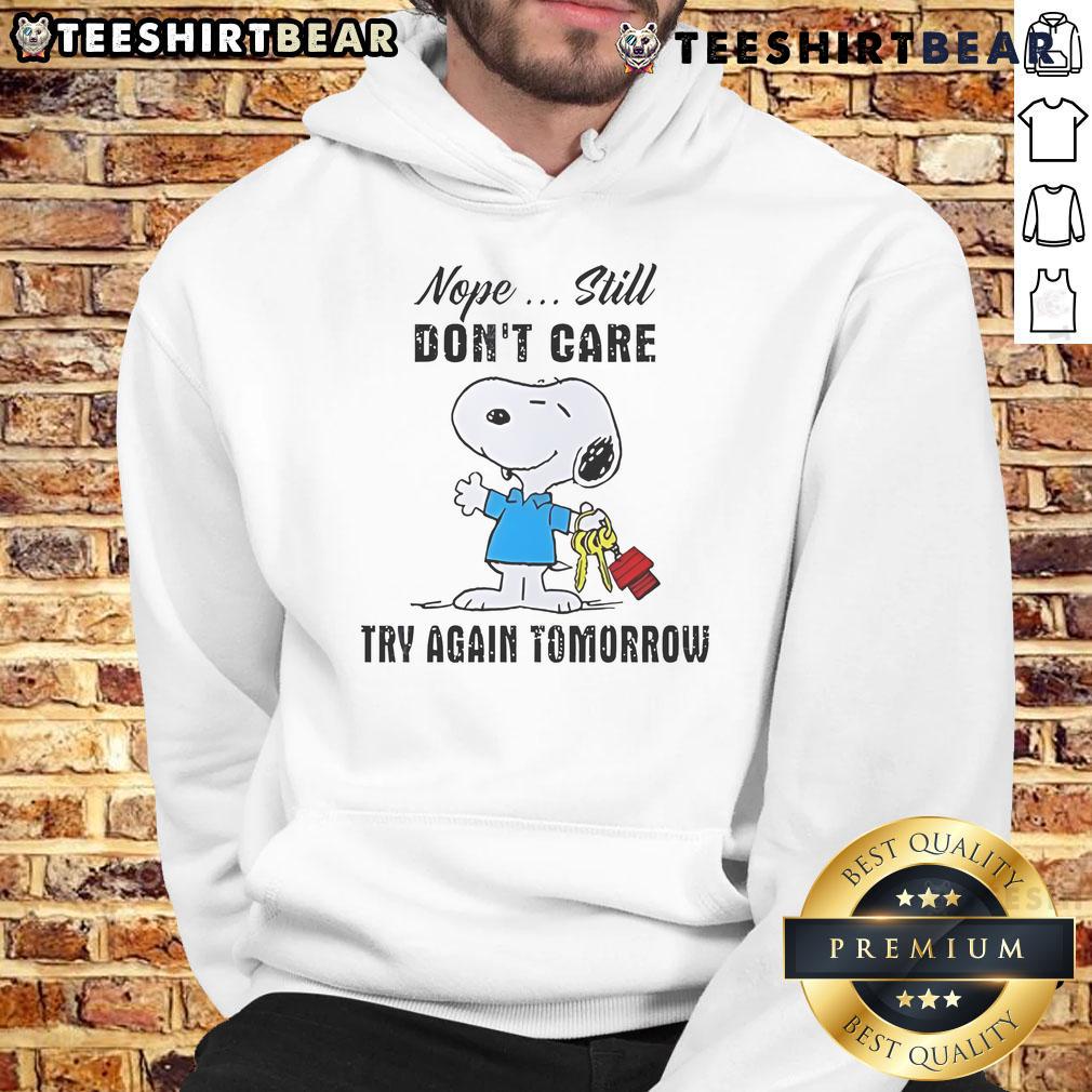Alt Text: Adorable Snoopy hoodie featuring 'Nope, still don't care, try again tomorrow' text, perfect for casual wear.