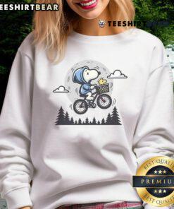 Cute Snoopy and Woodstock fly to the moon on a cozy sweatshirt, perfect for Peanuts fans and casual wear.